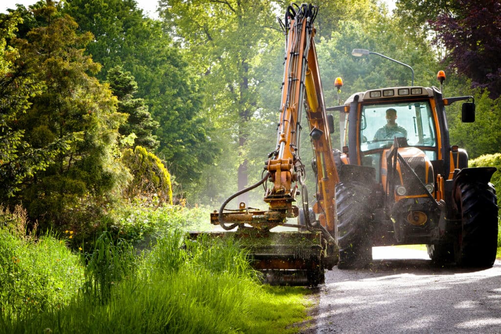 mowing grass verge  with tractor mower